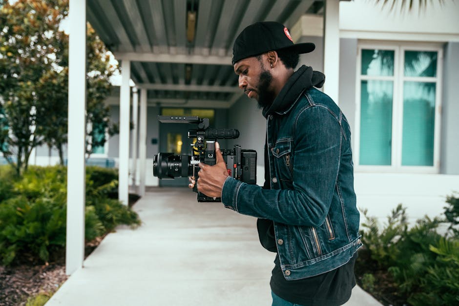 Professional wedding videographer adjusting cinema camera gear