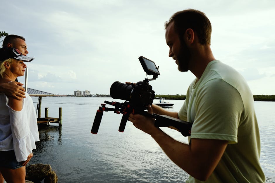 Wedding videographer capturing a bride and groom during golden hour